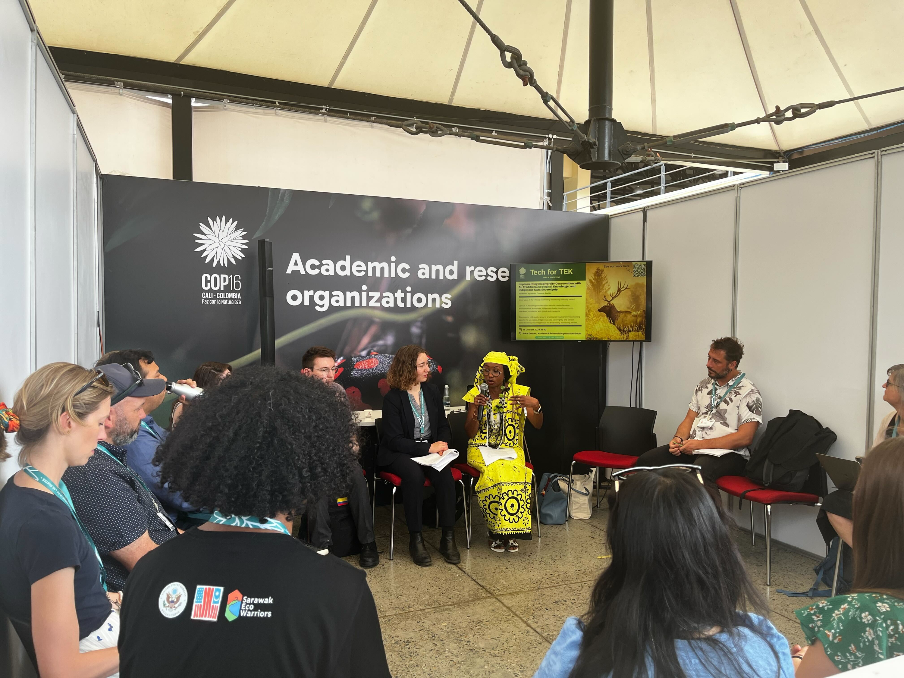 Hindou speaking at COP16 side event with attendees sitting in a circle around her