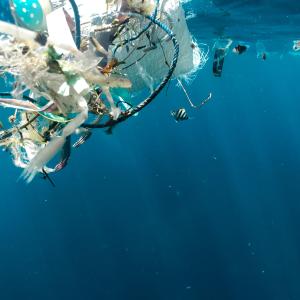 Plastics floating in clear blue water 